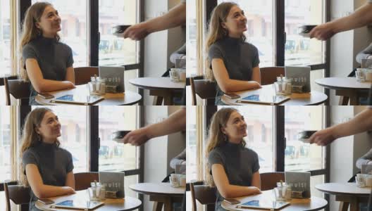 咖啡师在café为女性顾客提供咖啡高清在线视频素材下载