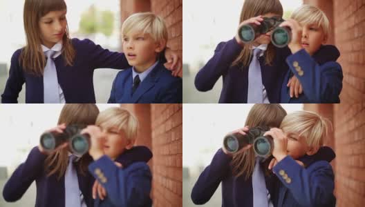 男生和女生玩双筒望远镜。高清在线视频素材下载