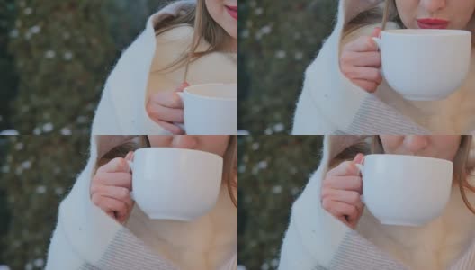 红唇少女冬天在户外喝热茶取暖高清在线视频素材下载