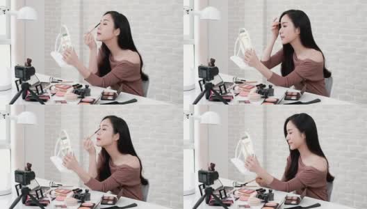 年轻的亚洲女性美容视频博主录制化妆教程高清在线视频素材下载