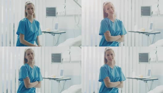 美丽的年轻护士迷人的微笑和交叉她的双臂。工作中有专业可靠的人。背景中的现代医院病房。高清在线视频素材下载
