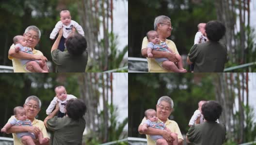 一对亚洲华人老夫妇和他们的孙子在自家前院玩高清在线视频素材下载
