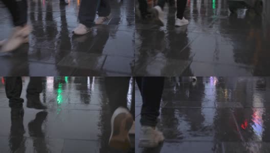 行人的脚步在雨后潮湿的路面上折射出城市的影子高清在线视频素材下载