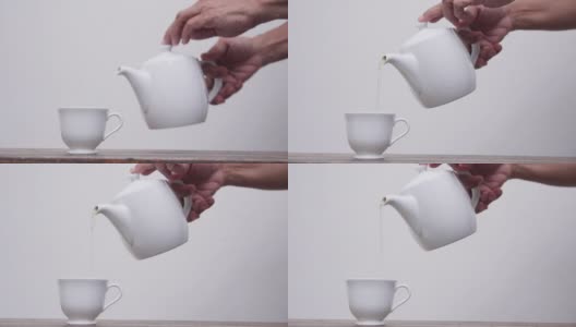 老女人把茶倒进白色背景的杯子里高清在线视频素材下载
