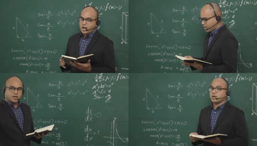 年轻的亚洲教师男子教授视频会议与学生。男性印度教师在课堂上通过在线课程培训数学。他戴着一副小小的谈话耳机。高清在线视频素材下载