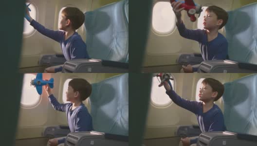 亚洲小男孩玩飞机模型玩具，坐在飞机上。这个孩子感到高兴和兴奋，想成为一名飞行员，作为他的梦想工作，当他长大后驾驶飞机。高清在线视频素材下载
