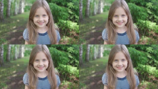 一个可爱的金发小女孩对着镜头微笑。近距离射击高清在线视频素材下载