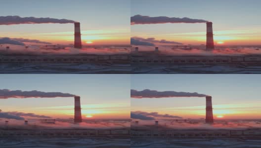 工厂的烟囱在日出时产生烟雾。垂直视频高清在线视频素材下载