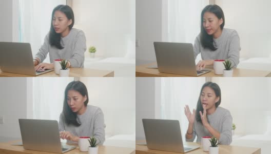 年轻的亚洲女商人使用笔记本电脑与同事在视频通话计划，同时在卧室智能工作。高清在线视频素材下载