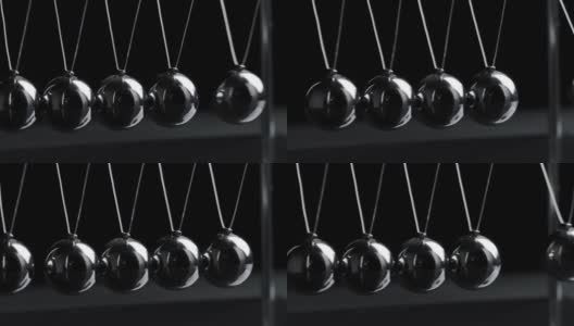 在黑色背景上悬挂牛顿球的镜头高清在线视频素材下载