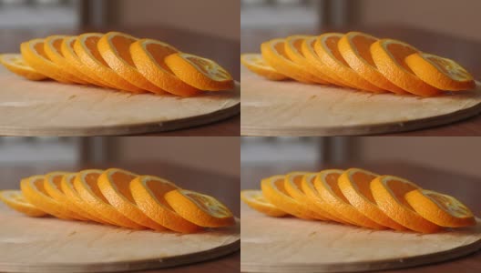在木板上切熟橙子，特写。高清在线视频素材下载