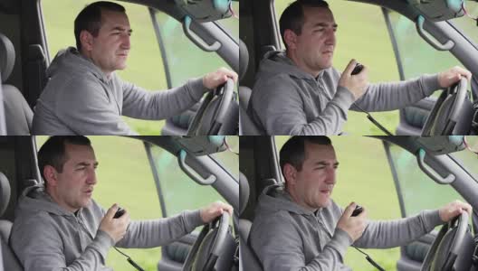 一个人拿着麦克风，在车里对着收音机讲话。高清在线视频素材下载