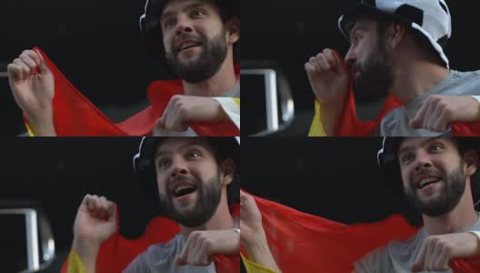 快乐的西班牙队球迷挥手亲吻国旗，胜利，慢镜头高清在线视频素材下载