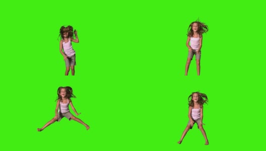 快乐的女孩在绿色的屏幕上跳上跳下高清在线视频素材下载