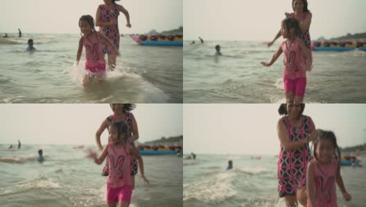 快乐的奶奶和孙女在海水里奔跑高清在线视频素材下载