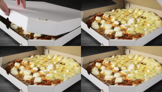 打开一个纸盒子，里面有新鲜出炉的披萨高清在线视频素材下载