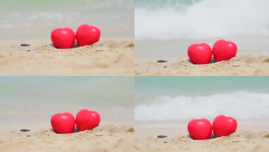 热带夏日沙滩上的两颗红心。情人节象征情侣概念。高清在线视频素材下载
