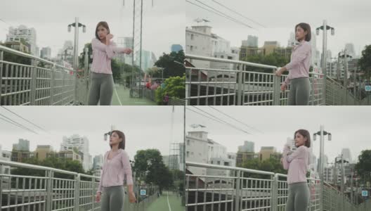 一个亚洲女人在楼下跑。人们早上慢跑锻炼高清在线视频素材下载