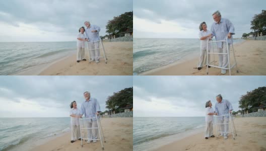 老人在沙滩上与walker和他的妻子一起锻炼。人有医疗、医疗和退休的概念。高清在线视频素材下载