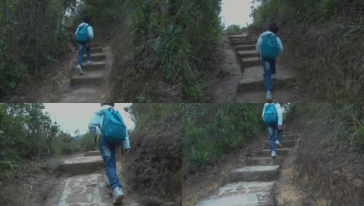 亚洲男孩沿着山路徒步旅行高清在线视频素材下载