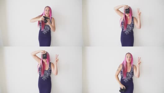 粉色头发的女孩用老式相机拍照高清在线视频素材下载