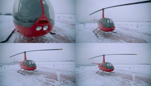 冬天，一架红色的直升机停在着陆点。高清在线视频素材下载