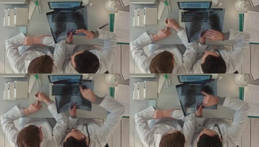 俯视图医生讨论肠道x光在医疗办公室高清在线视频素材下载
