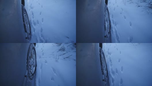开车穿过厚厚的积雪，相机上的雪花飘动高清在线视频素材下载