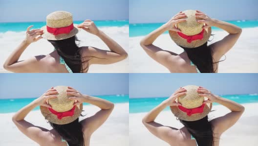 戴着帽子的年轻女子在热带海滩上看着美丽的大海高清在线视频素材下载