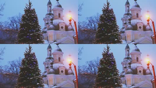 派尔努,爱沙尼亚。圣诞树在节日新年节日照明和圣凯瑟琳东正教教堂的背景高清在线视频素材下载