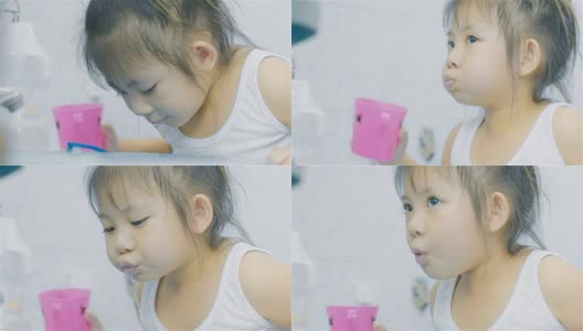 亚洲小女孩在浴室刷牙后漱口高清在线视频素材下载