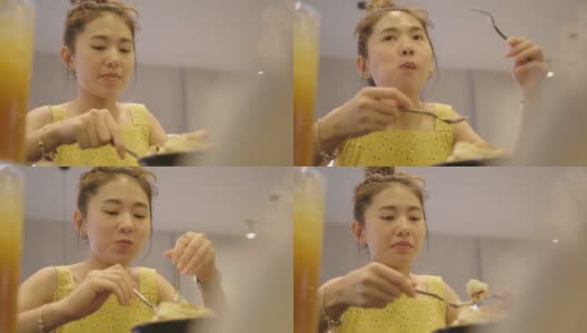 亚洲女人在咖啡馆吃蜂蜜吐司假日，周末高清在线视频素材下载