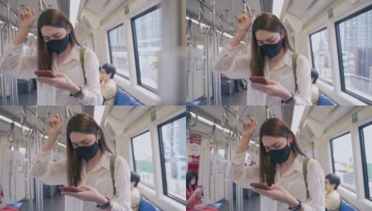 20-30岁的亚洲裔女性，穿着休闲服装，正在使用该服务使用公共交通工具，乘客乘坐电梯在火车共享服务形式的新冠肺炎疫情下，重新开启旅行高清在线视频素材下载