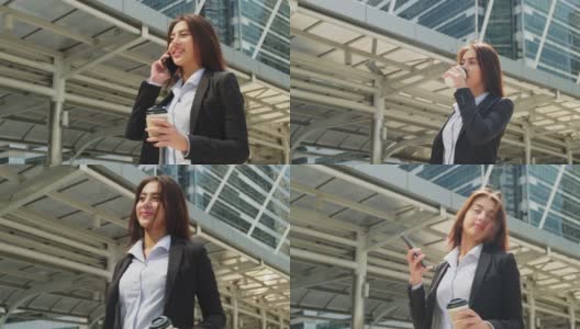 亚洲年轻精明的女商人在城市里打电话。拿着咖啡杯的女孩微笑着走到外面的办公室。以电信和移动网络为经营理念。高清在线视频素材下载