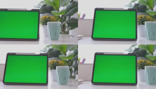 空白绿屏数字平板站在家里的工作台上，模拟，模板，技术概念高清在线视频素材下载