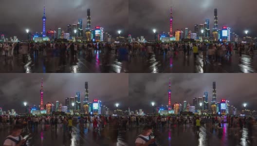 时间流逝:在上海外滩观光景点，人们在陆家嘴摩天大楼灯光秀上散步并拍照。高清在线视频素材下载