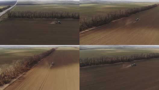 农用拖拉机在日落时喷洒喷雾剂、除草剂和杀虫剂的鸟瞰图。农机农业自然季节性春季工作高清在线视频素材下载