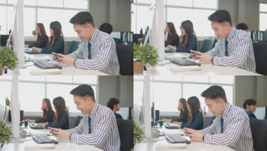 懒惰的亚洲商人在办公室玩游戏，把工作时间花在打电话上，同事履行职责高清在线视频素材下载