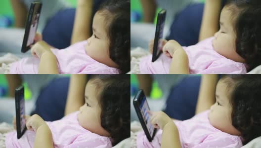 女婴使用智能手机高清在线视频素材下载