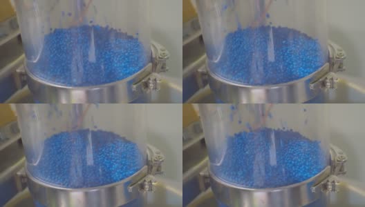 蓝色塑料颗粒在生产设备的移动。特写高清在线视频素材下载