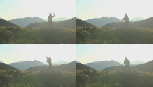剪影中的男子在山上练习武术，锻炼身体高清在线视频素材下载