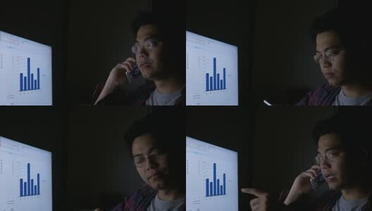亚洲男人打电话和工作笔记本电脑在晚上高清在线视频素材下载