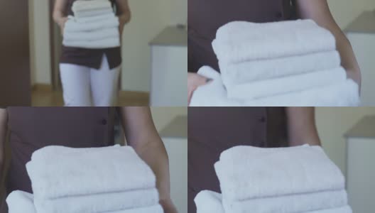 服务员负责酒店套房的清洁工作，并为客人提供干净的毛巾高清在线视频素材下载