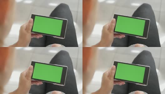 金发女性手握绿色屏幕手机展示高清在线视频素材下载