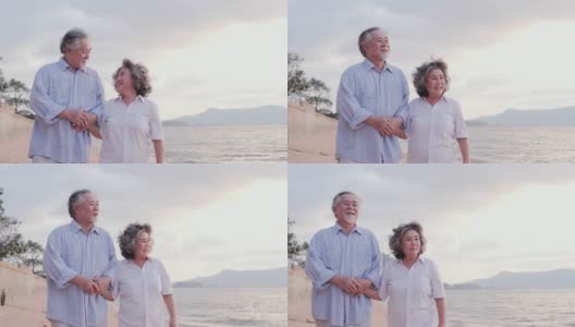 年长的亚洲夫妇站在海滩上，心情愉快。有生活方式、情感和退休观念的人。高清在线视频素材下载