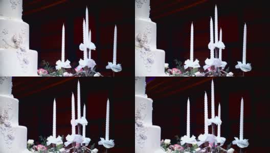 在婚宴上装饰蜡烛的漂亮的婚礼蛋糕。高清在线视频素材下载