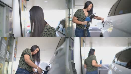 年轻女子在加油站给她的车加油高清在线视频素材下载
