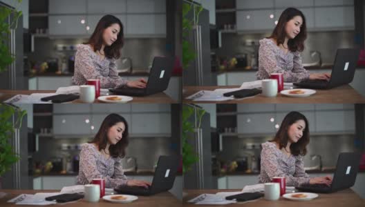 一位亚裔中国美女在家工作，作为客户服务，用厨房里的笔记本电脑在线回答客户的问题高清在线视频素材下载