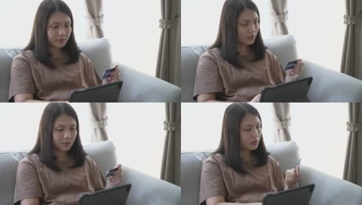 女人在家沙发上用电子平板电脑网上购物高清在线视频素材下载