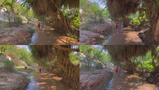 Slowmotion。在越南南部的梅尼村，一个家庭沿着沙漠边界的红色峡谷或仙女溪散步。用手机拍摄高清在线视频素材下载